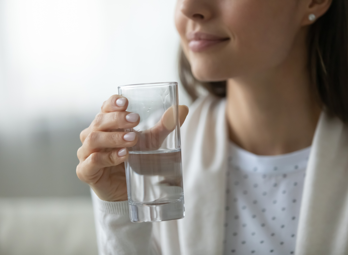 woman holding a glass of water