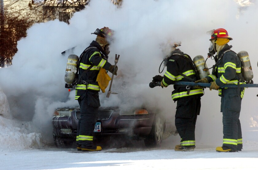 Firefighters in burning car January 2009