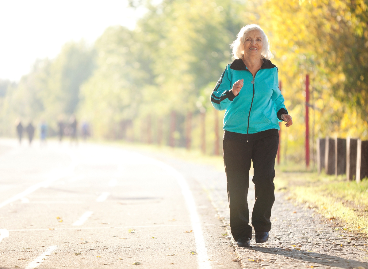 happy elderly woman taking a walk, exercising and staying healthy to become a centenarian