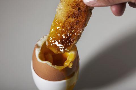 man eating soft-boiled egg