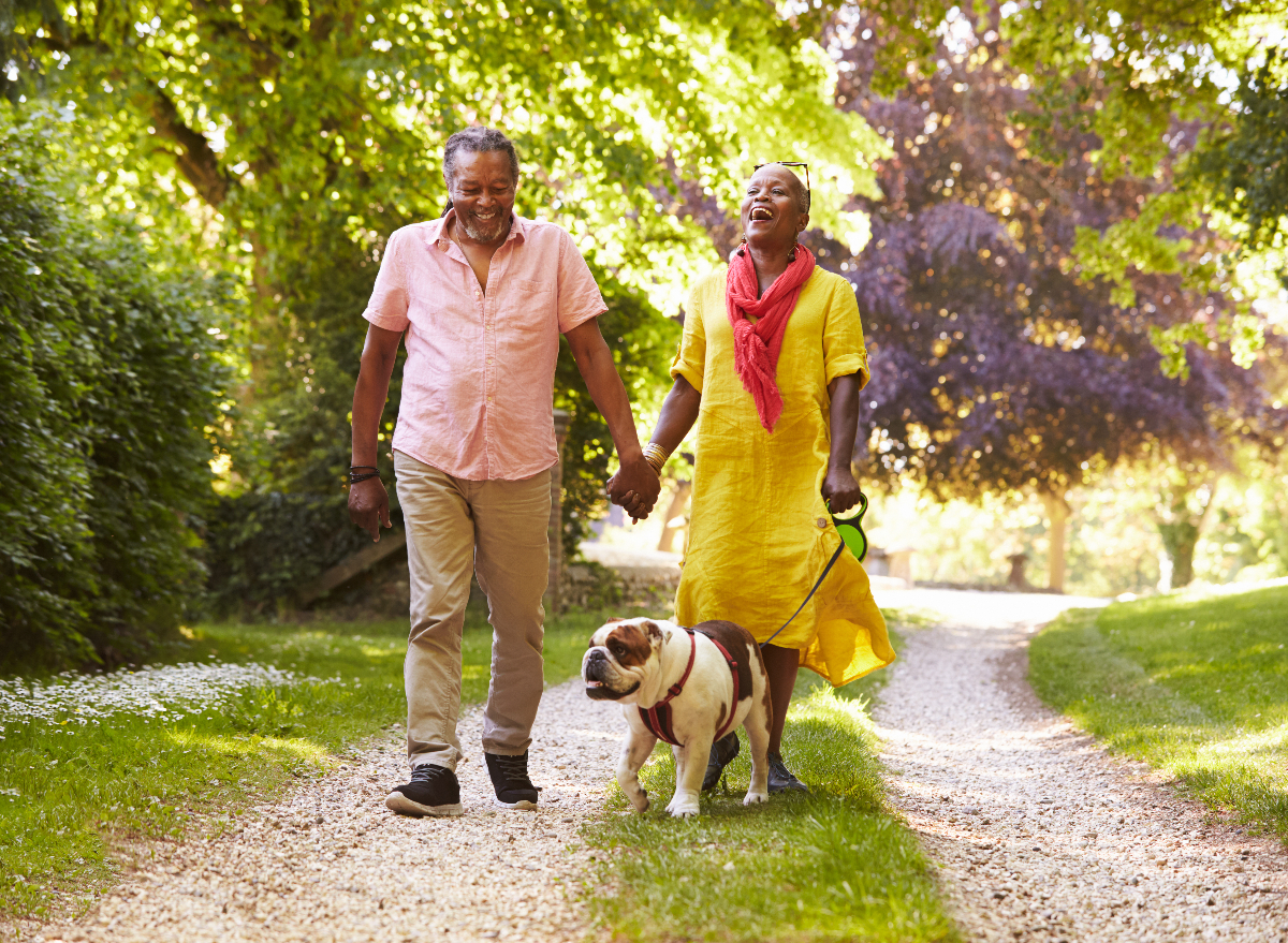 mature couple walking the dog