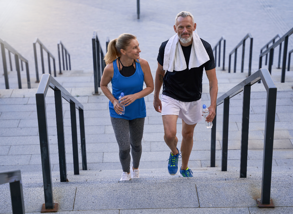 mature couple taking stairs, walking habits that delay aging