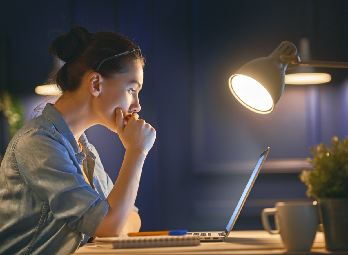 woman working on a laptop by the light