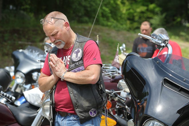 Brian Flanagan of Pepperell prays the Lord's Prayer during the "motorcycle blessing"May 21, 2022.