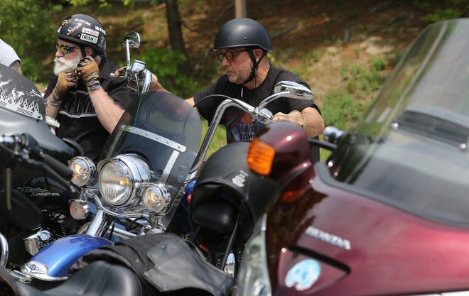 Paul Copley, left, of Lowell and Sal Carcia, of Salem, NH, arrive for the "Blessing of Motorcycles in Chelmsford, May 21, 2022. It was sponsored by the Cross Bearers Catholic Motorcycle Ministry.