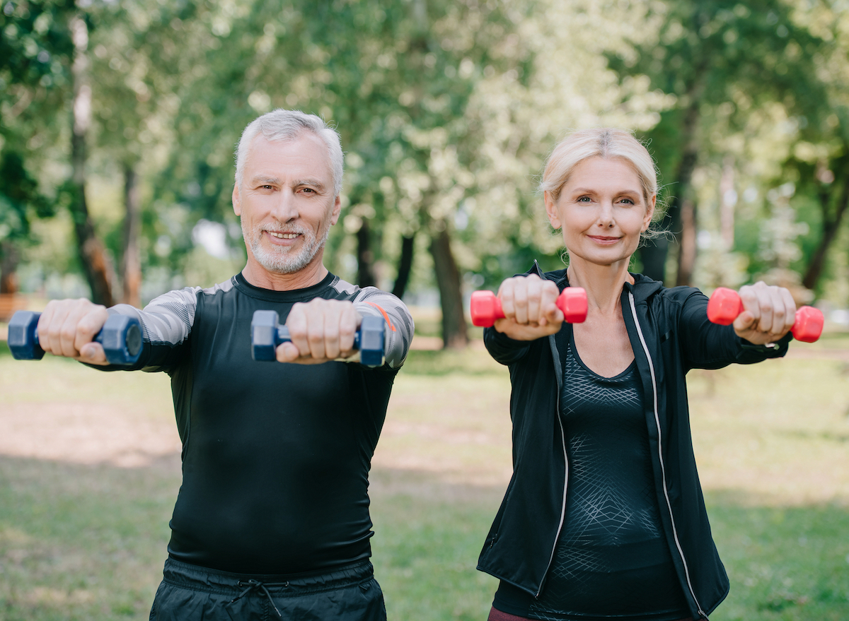 partner strength training outdoors with weights, wellness habits that slow down aging