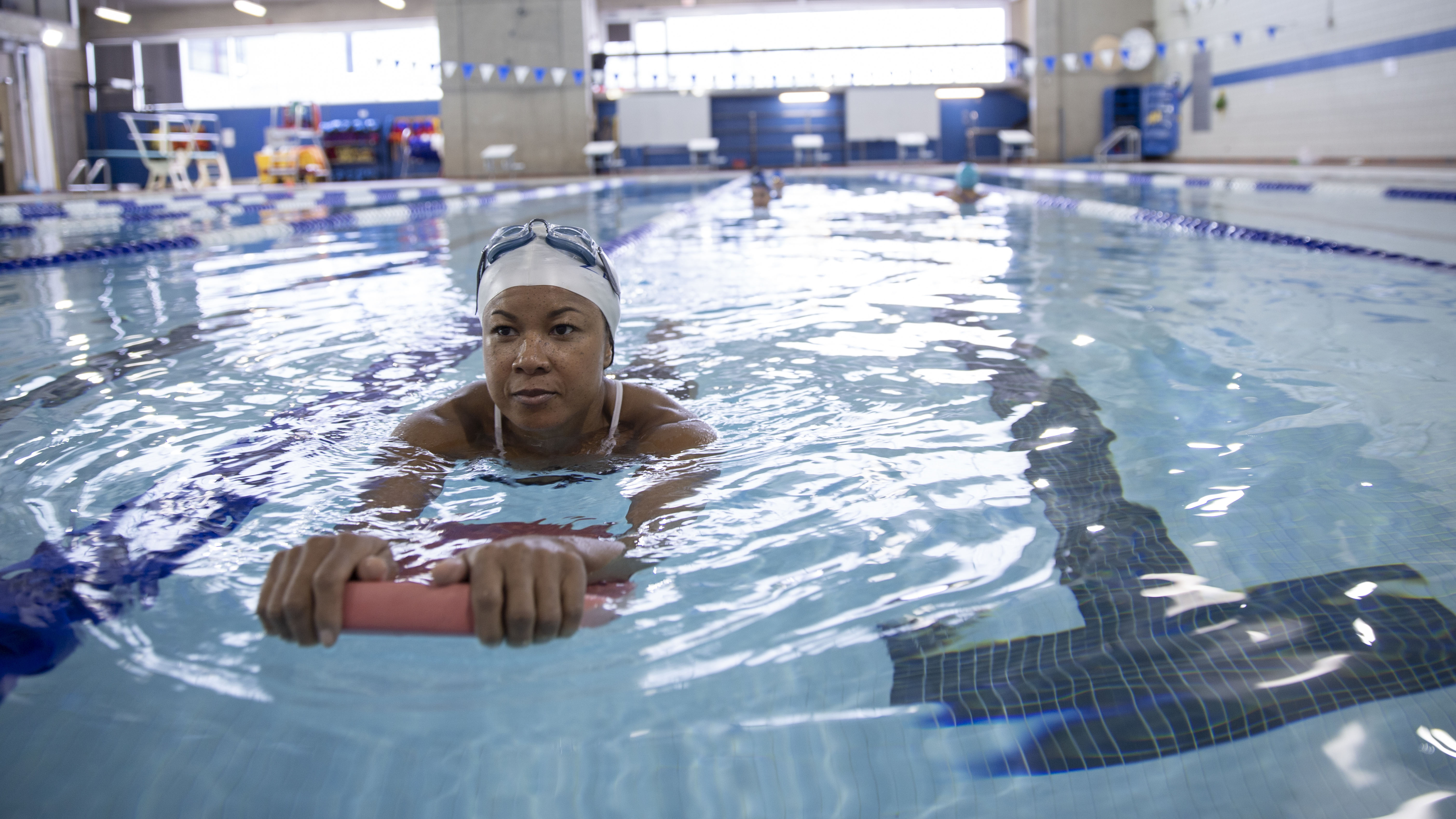 Person using floating aid to swim with legs