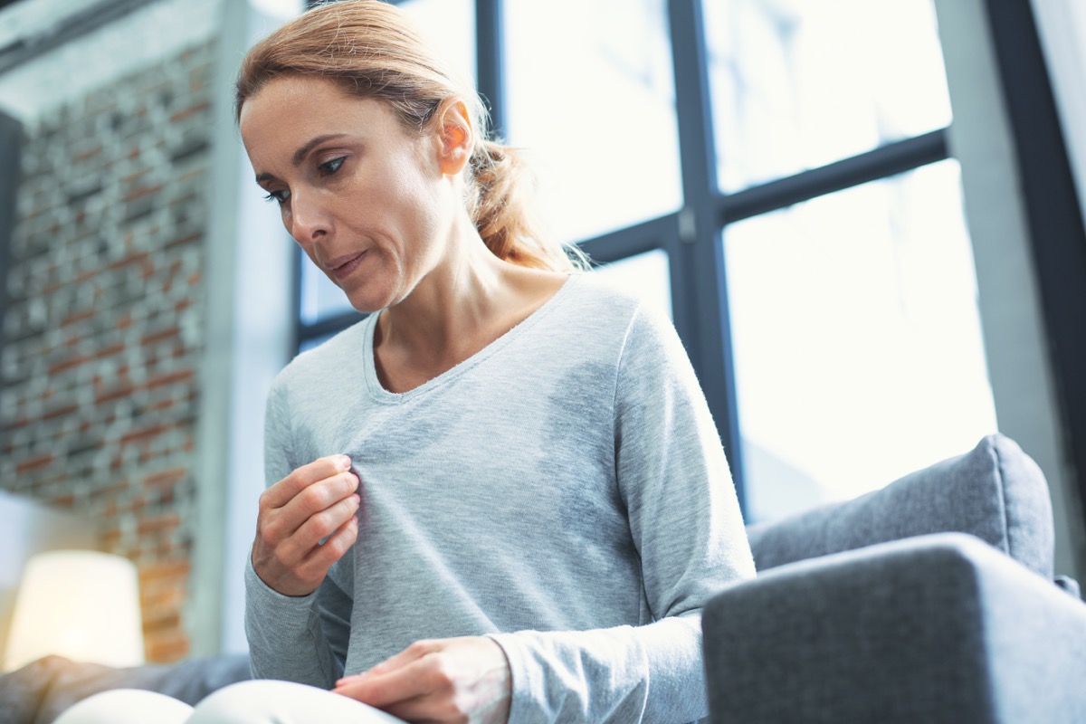 sweating woman wearing sweater