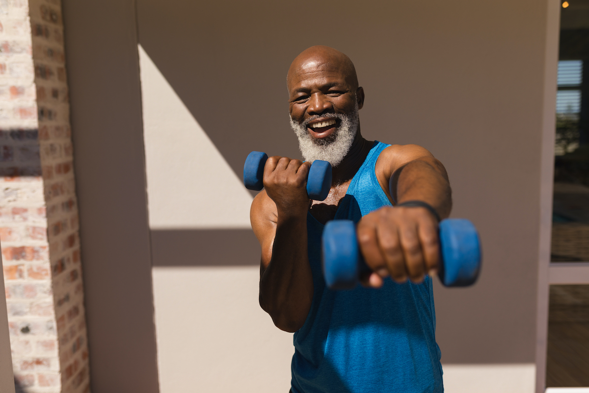 An elderly woman stretches during her workout.  Mature woman exercising.  Portrait of a fit senior woman doing stretching exercise in the park.  Senior sportsman doing stretching exercises