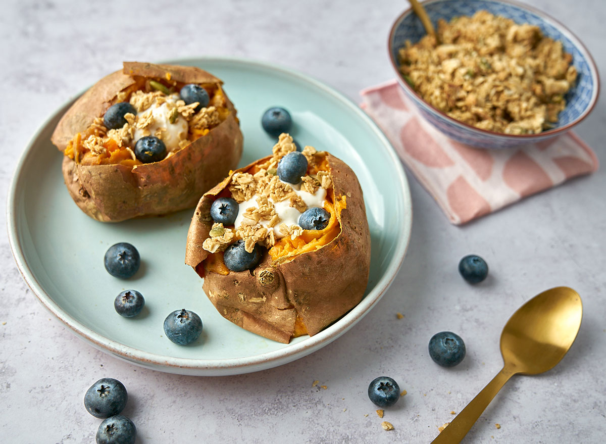 sweet potato breakfast on blue plate with blueberries and yogurt