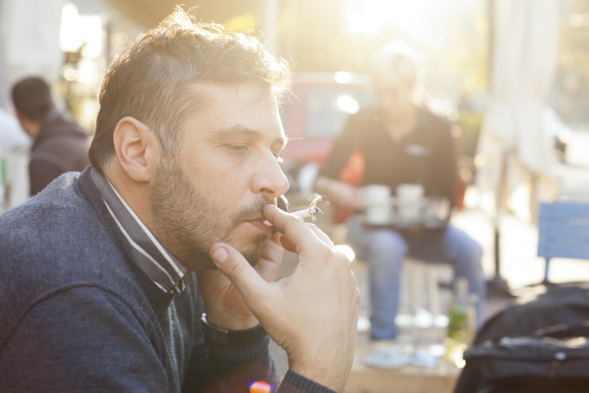 Man smoking on a bright sunny day outdoors