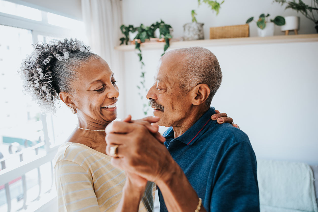 Senior couple smiling and dancing with each other