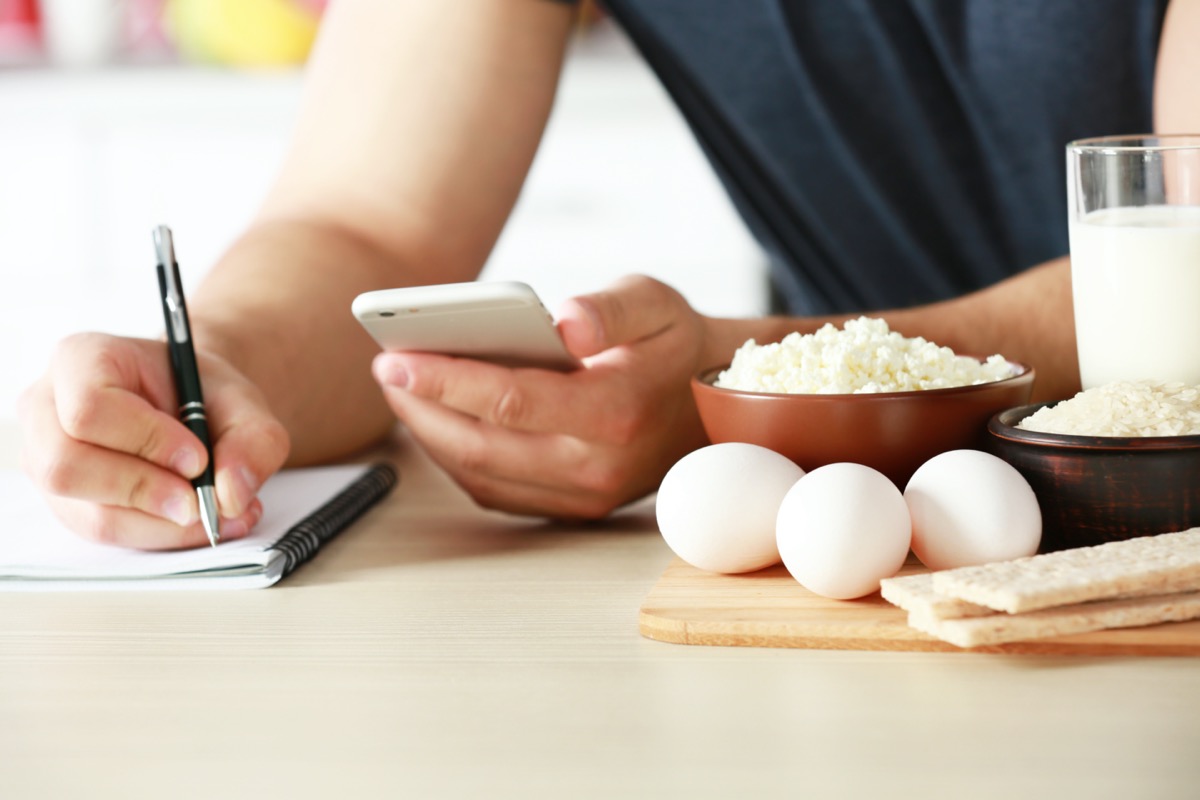 Man counting calories at table