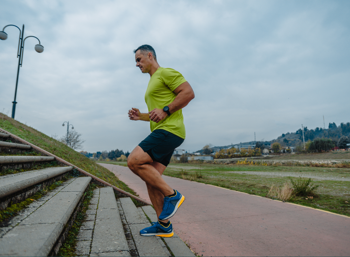 middle-aged man exercising on the stairs, demonstrating the cardio habits that age him faster