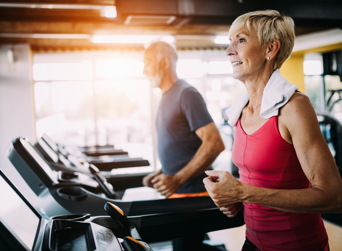 mature woman exercising on treadmill in gym