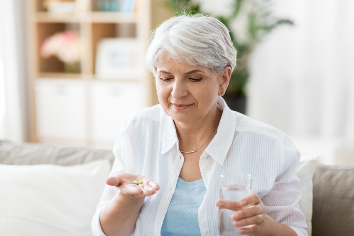 old woman taking pills