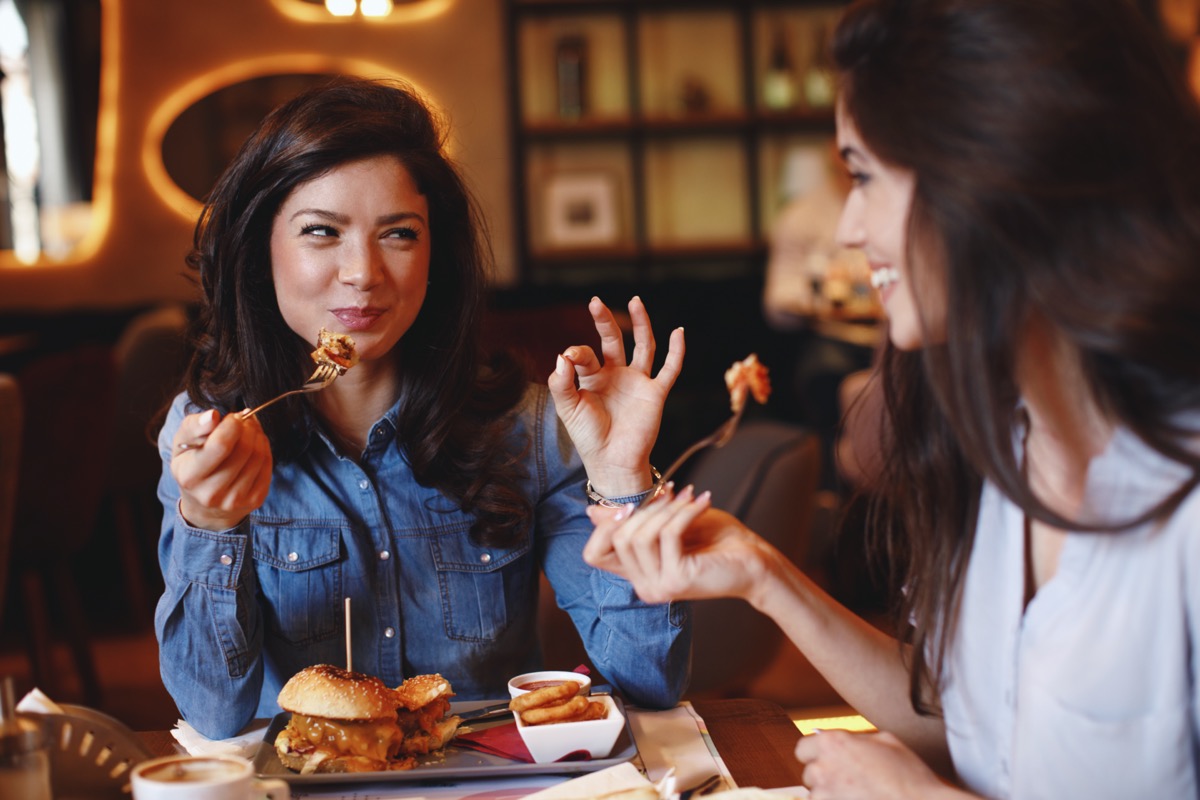 Two young women having lunch in a restaurant.