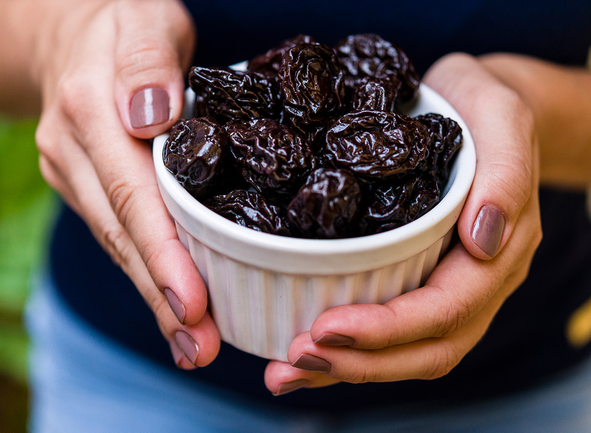 holding a plate of prunes