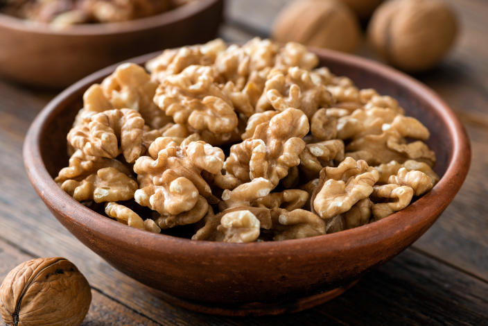 Walnuts in brown bowl.  (fake images)