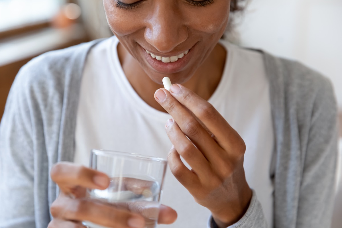 Woman taking vitamins