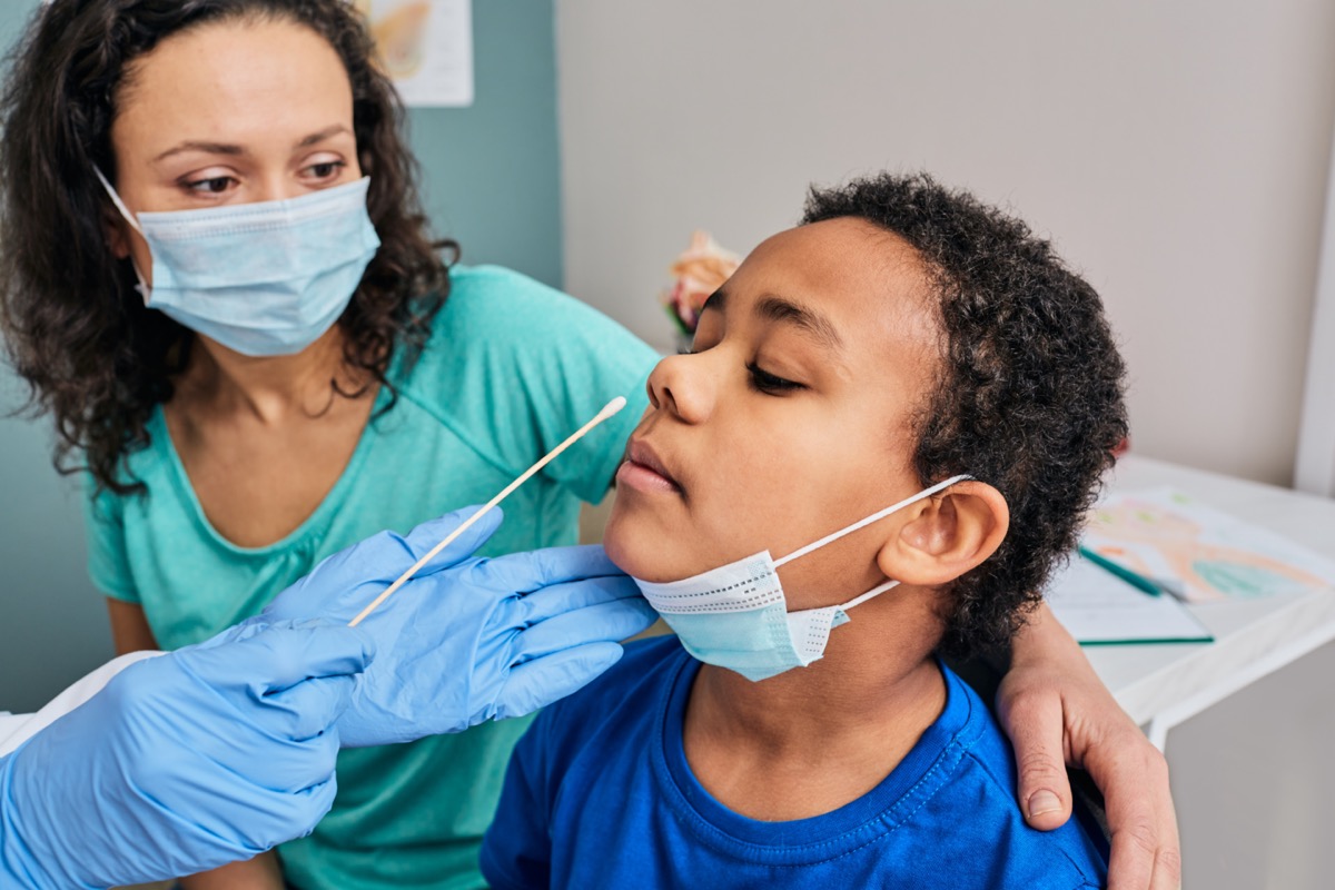 African American boy with his mother during coronavirus PCR test in a medical laboratory