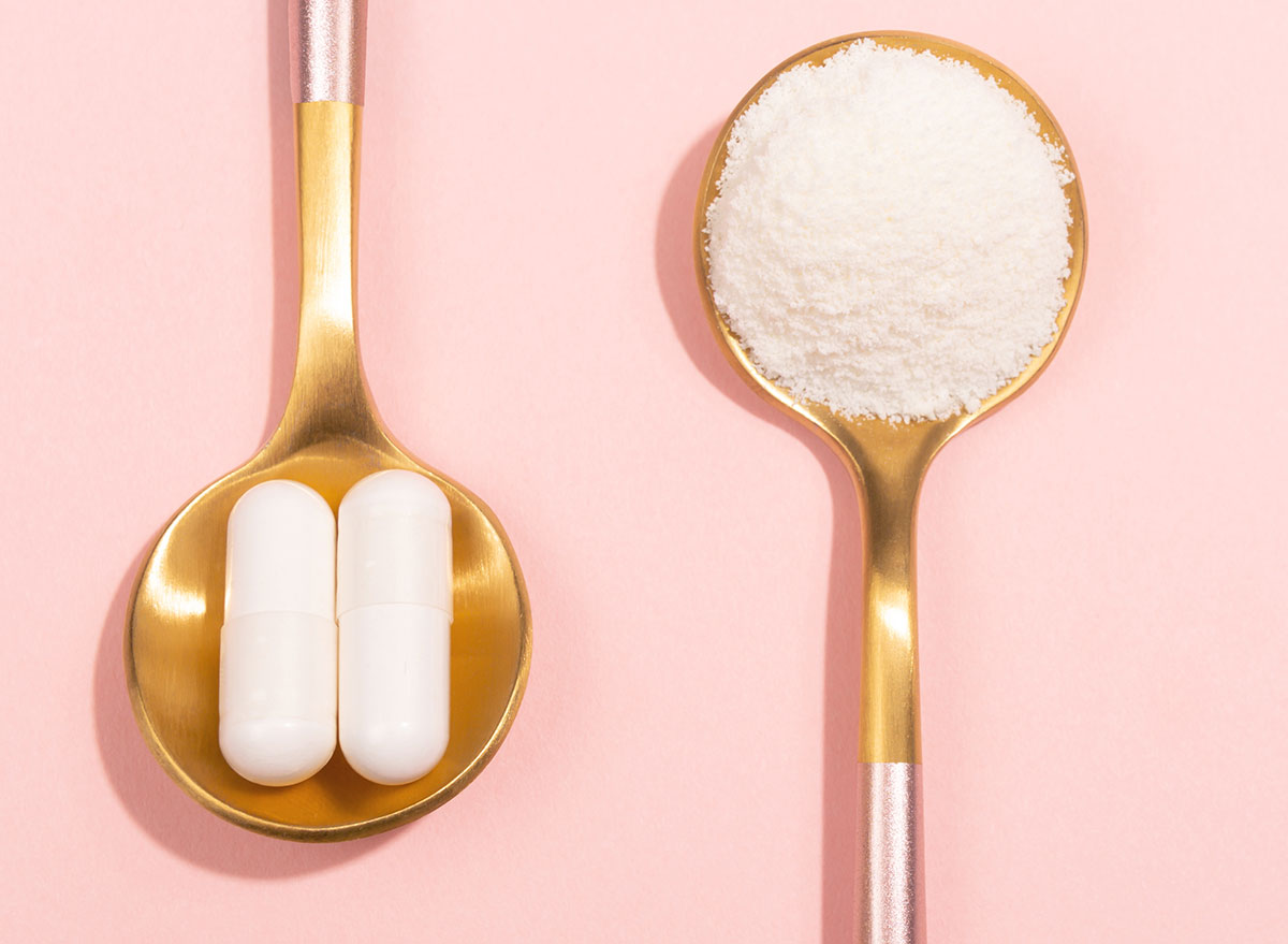 collagen pills and powder on pink background of gold spoons