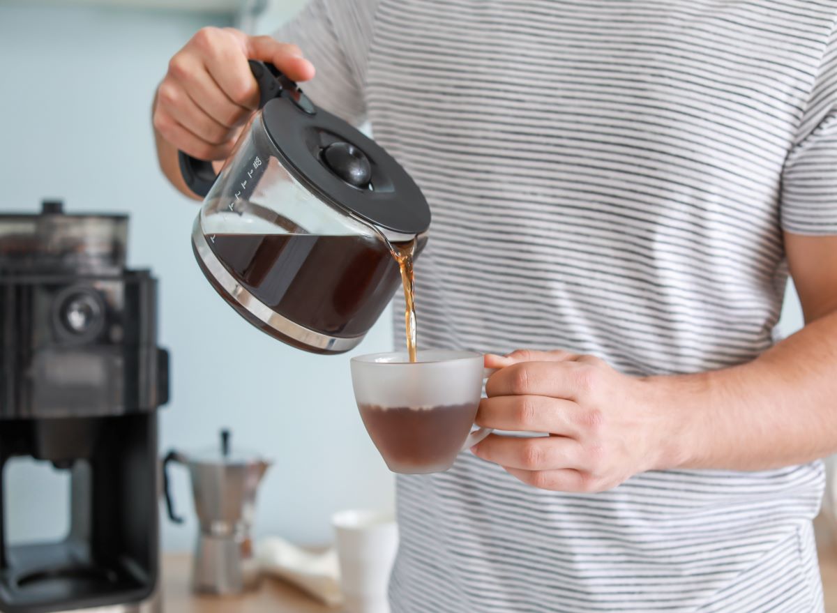 man pouring coffee from pot