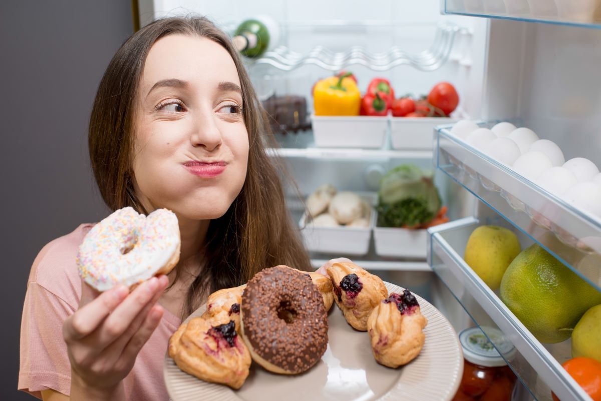 Woman eating sugary junk food