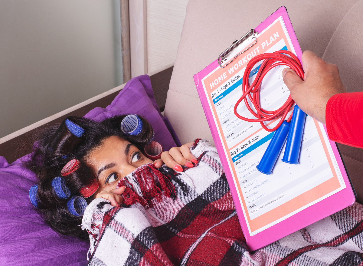 sedentary woman in curlers does not want to exercise, demonstrates habits that give her a bigger waist