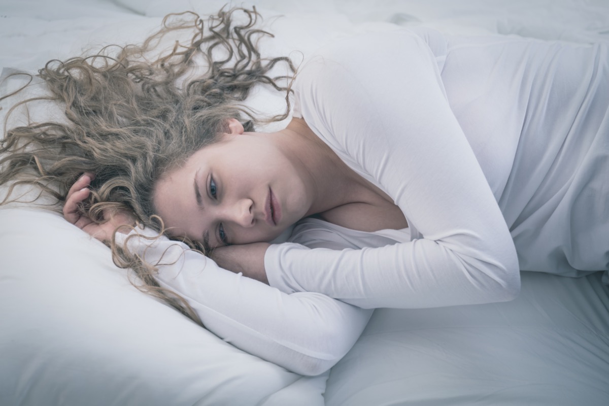 Woman lying in bed.