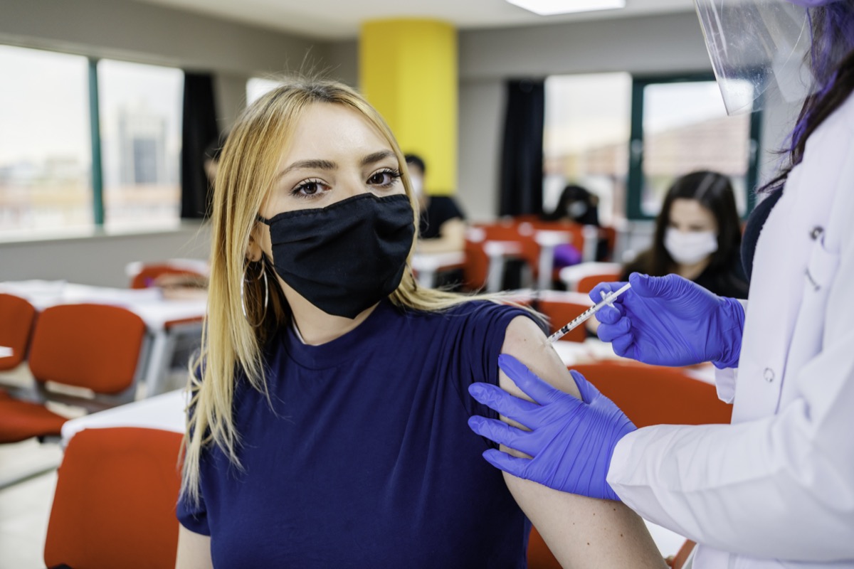 Nurse gives students a vaccine at school during the coronavirus pandemic