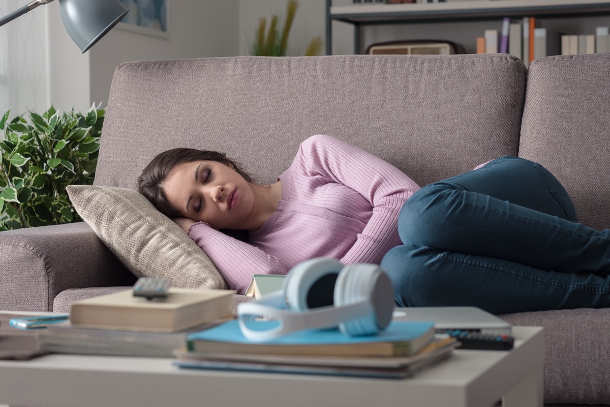 Woman sleeping on the sofa in the living room.