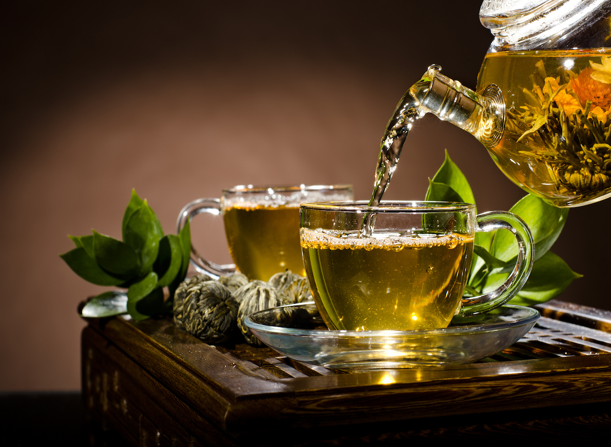 pouring green tea into cup