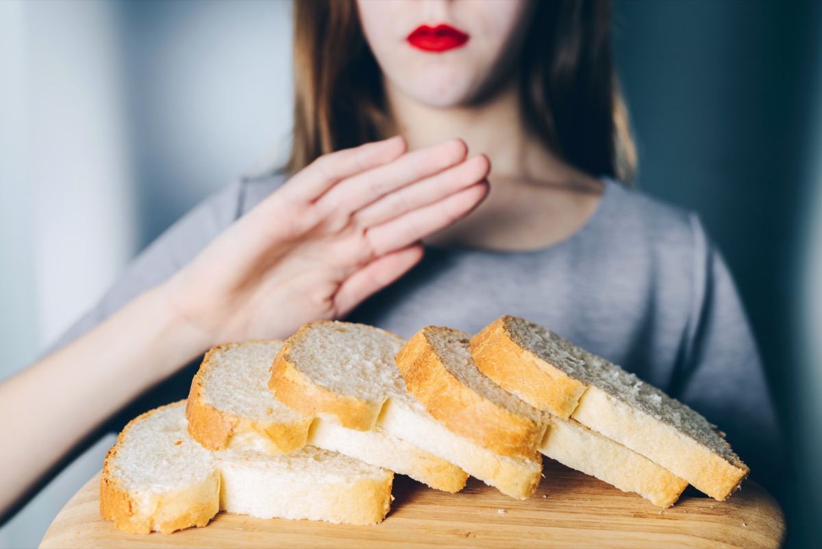 Woman refuses to eat white bread.  shallow depth of field