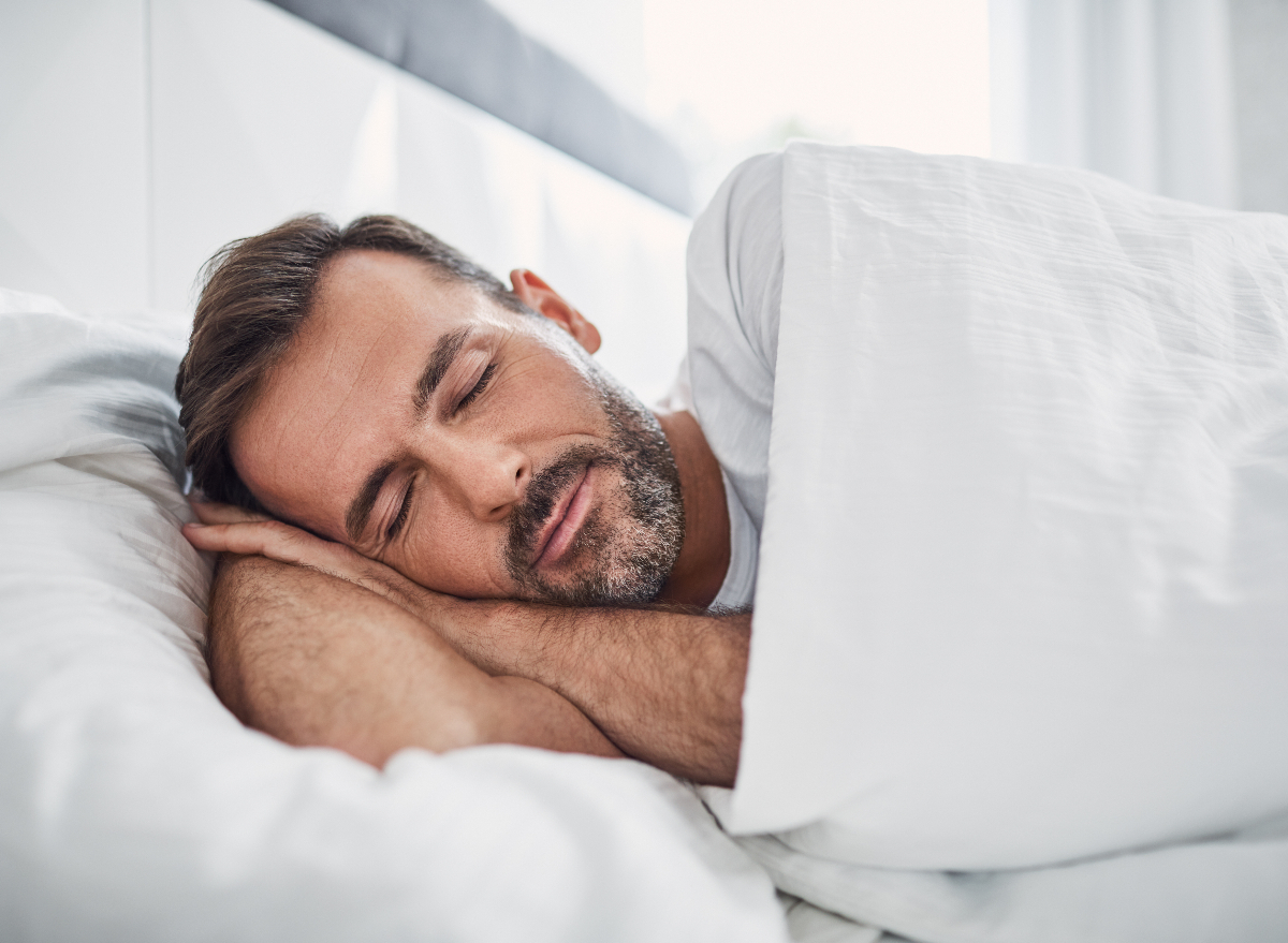 man sleeping in a bright room