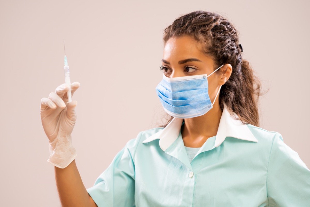 nurse holding syringe