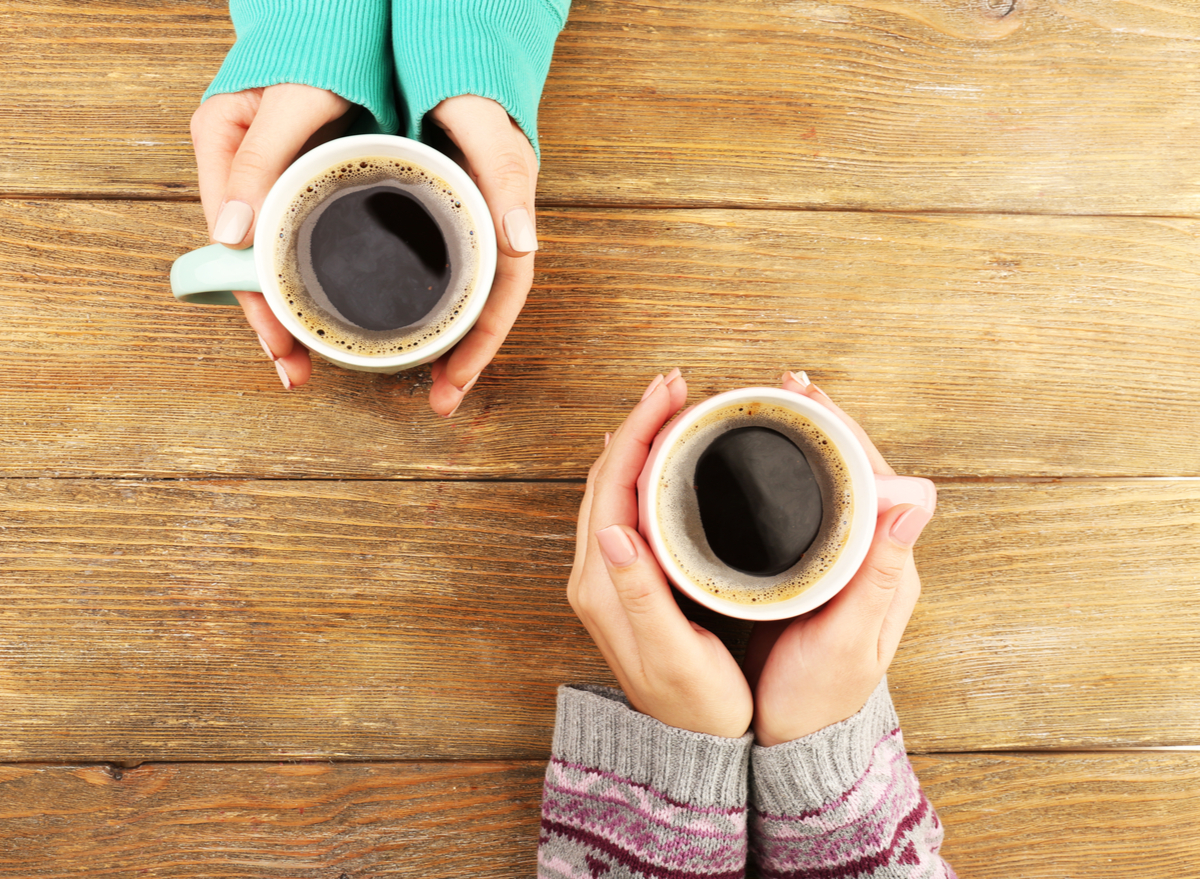 holding cups of coffee