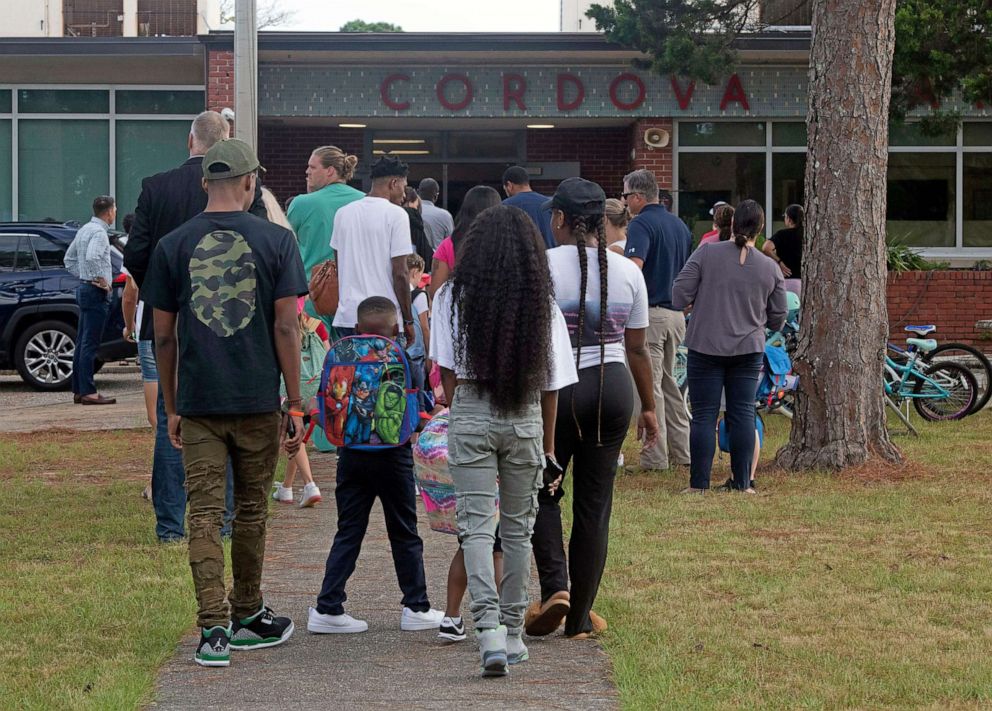 PHOTO: Parents and families walk their children to Cordova Park Elementary School on the first day of school, Aug. 10, 2022, in Florida. 