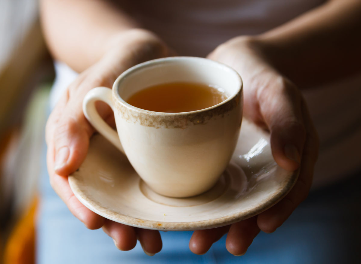 woman holding a cup of tea in her hands