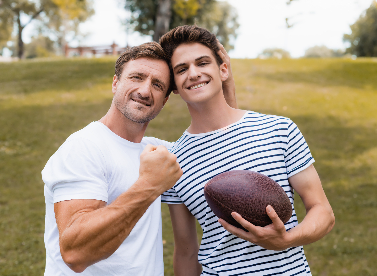 father and son playing soccer