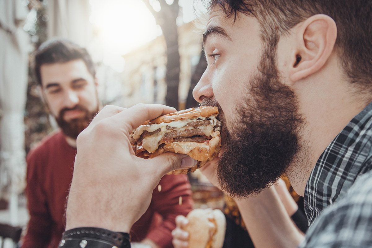 man eating a hamburger