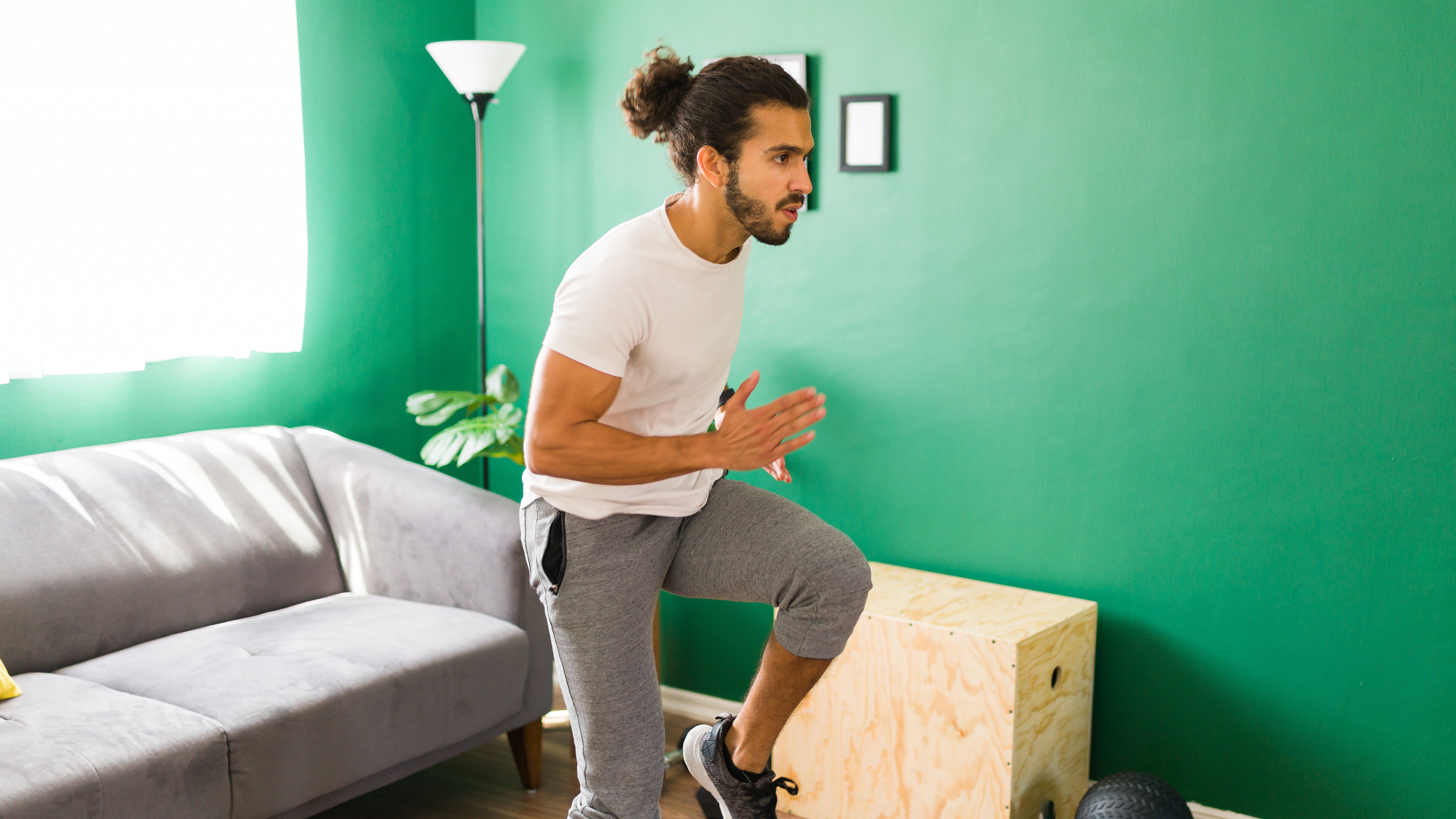 Man doing Tabata workout regimen in living room