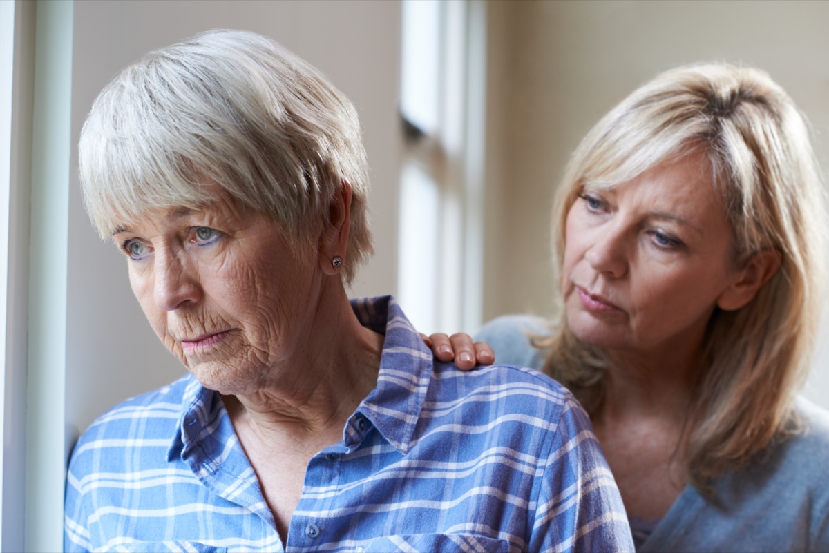 elderly woman with adult daughter at home.