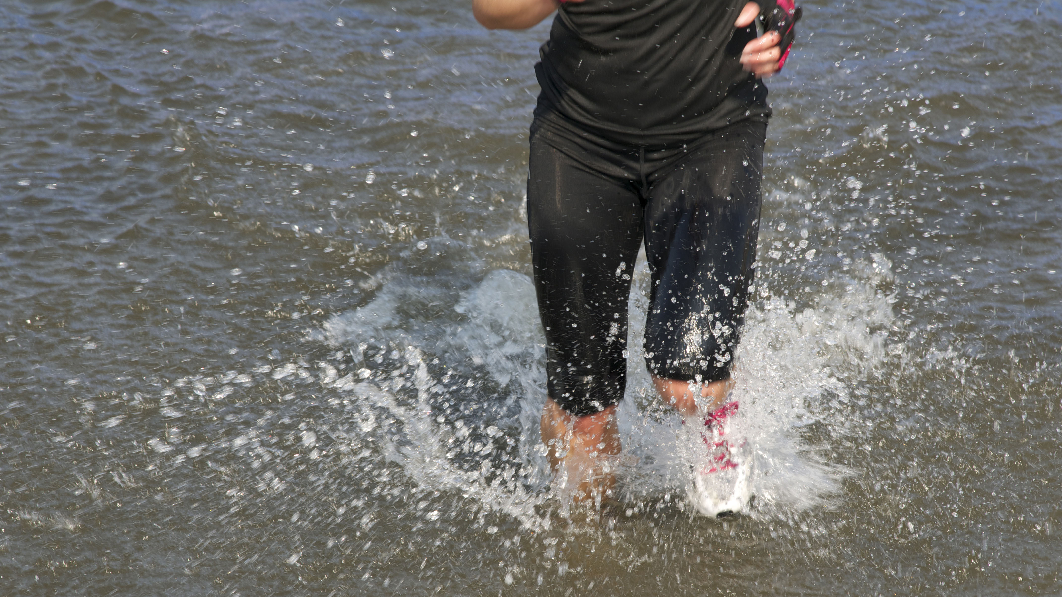 Person running in water outdoors