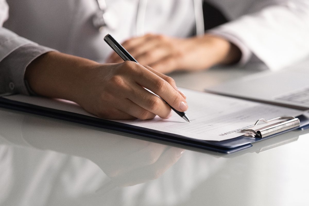 doctor taking notes for patient research