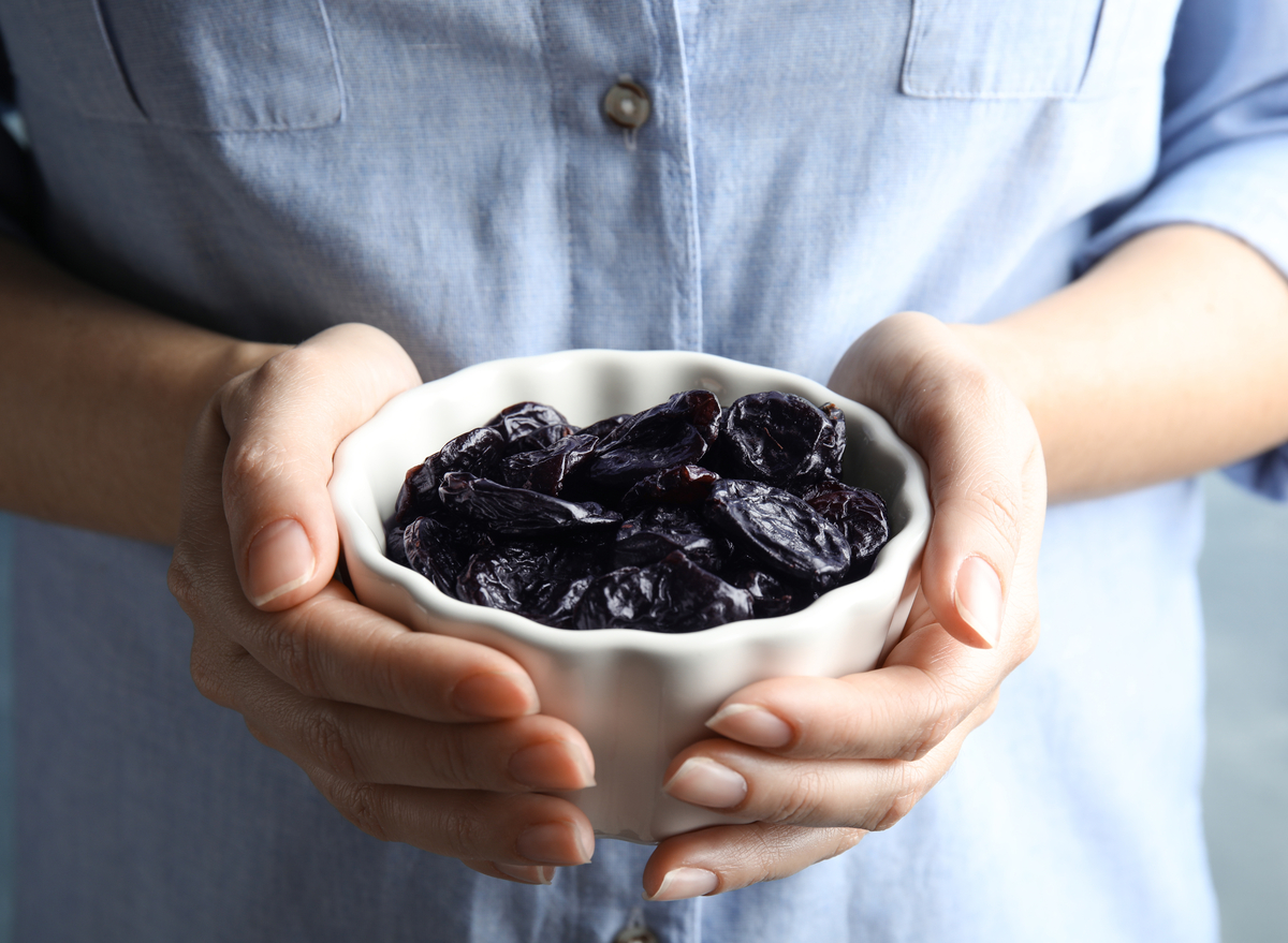 holding a bowl of prunes