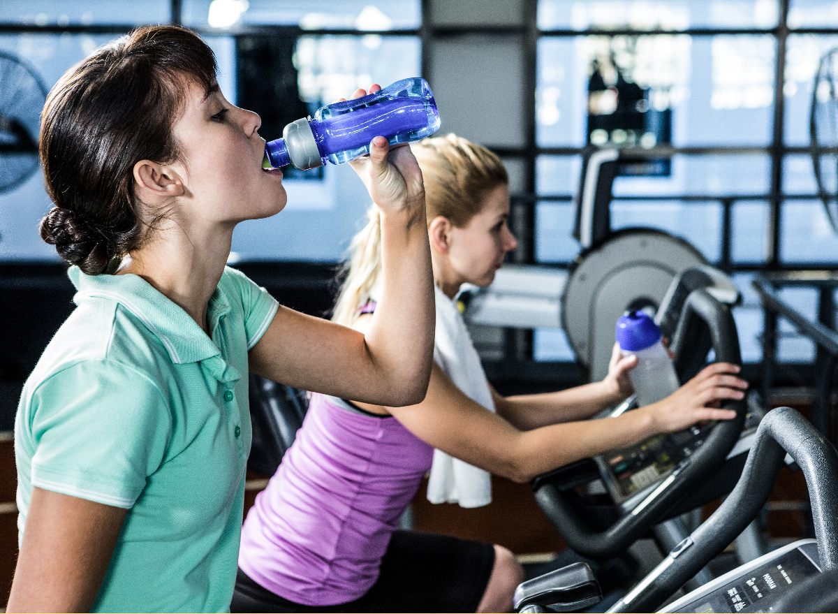 woman on a bike, proving that you should drink water while exercising