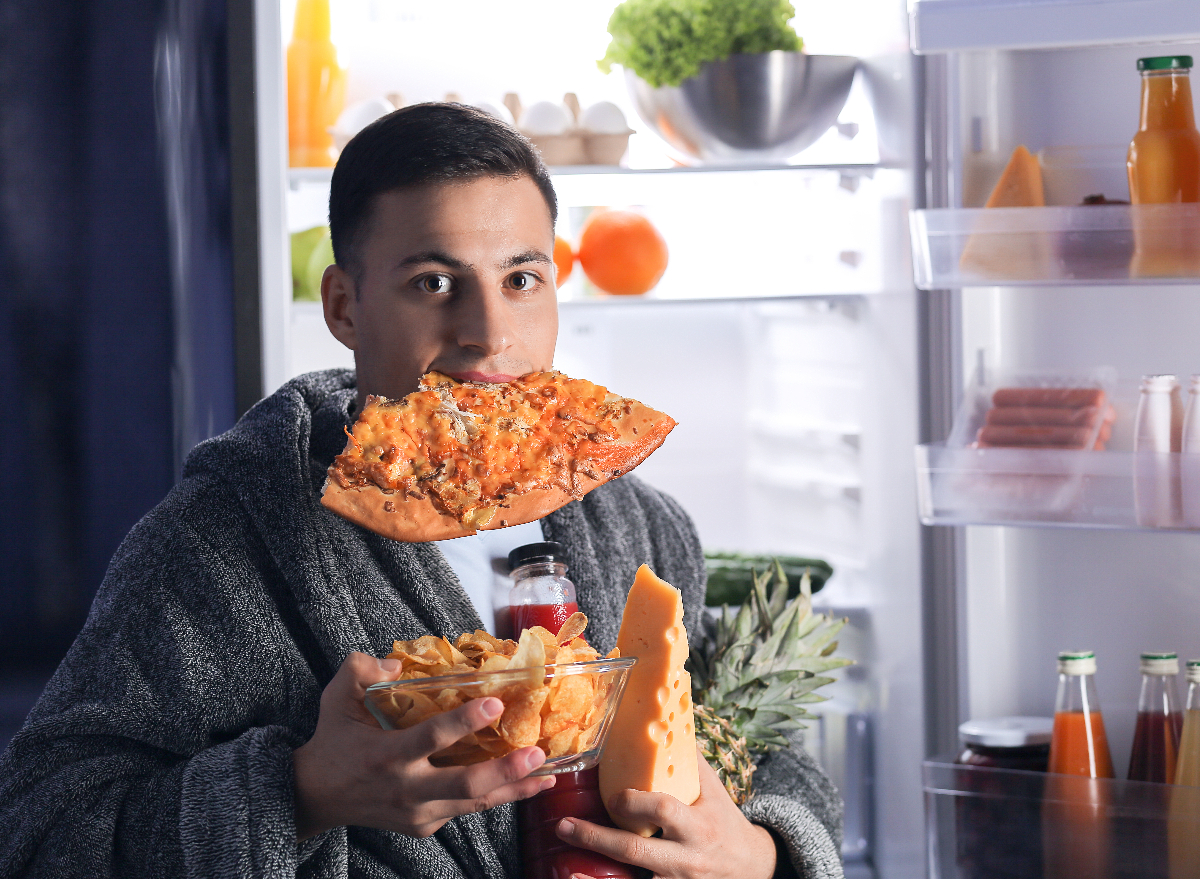 man eating snacks late at night