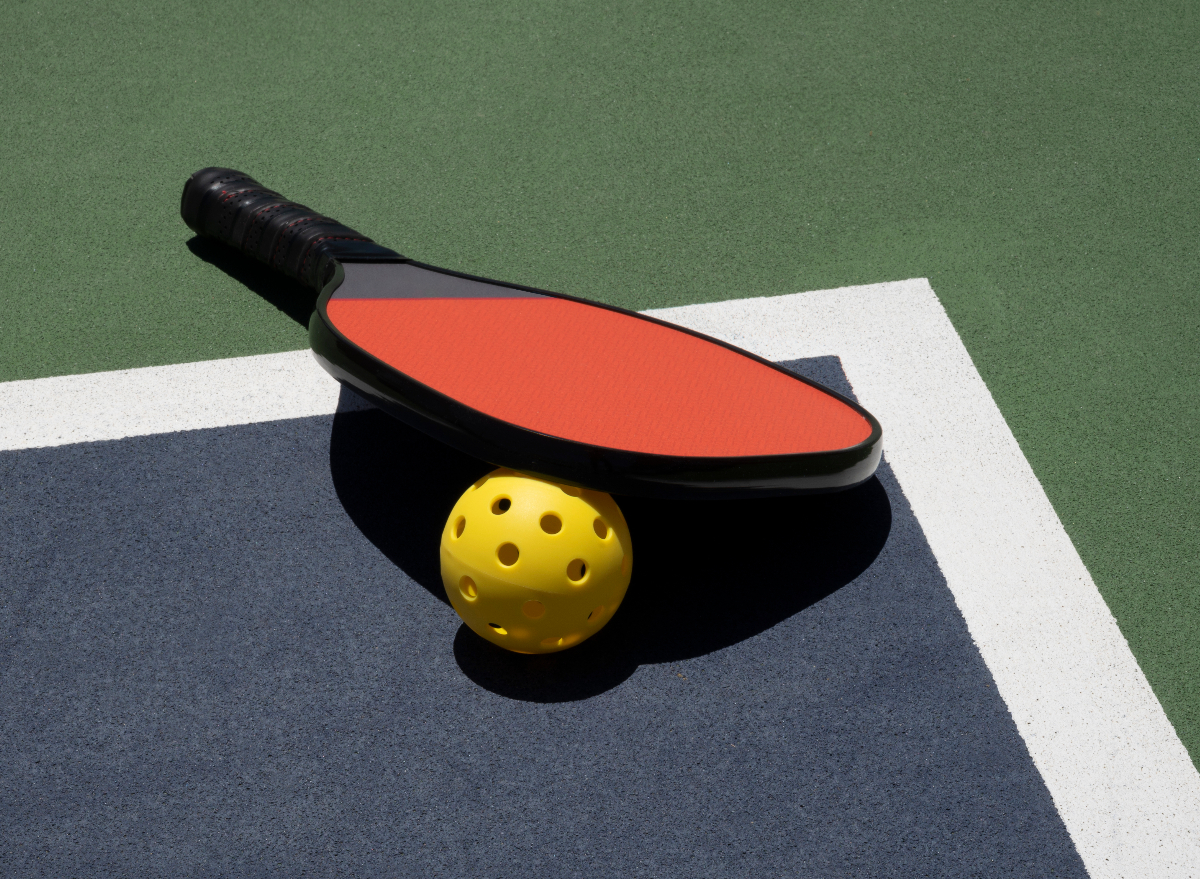 pickleball paddle and ball on the court