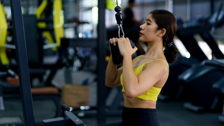 athlete on a cable machine doing pull downs